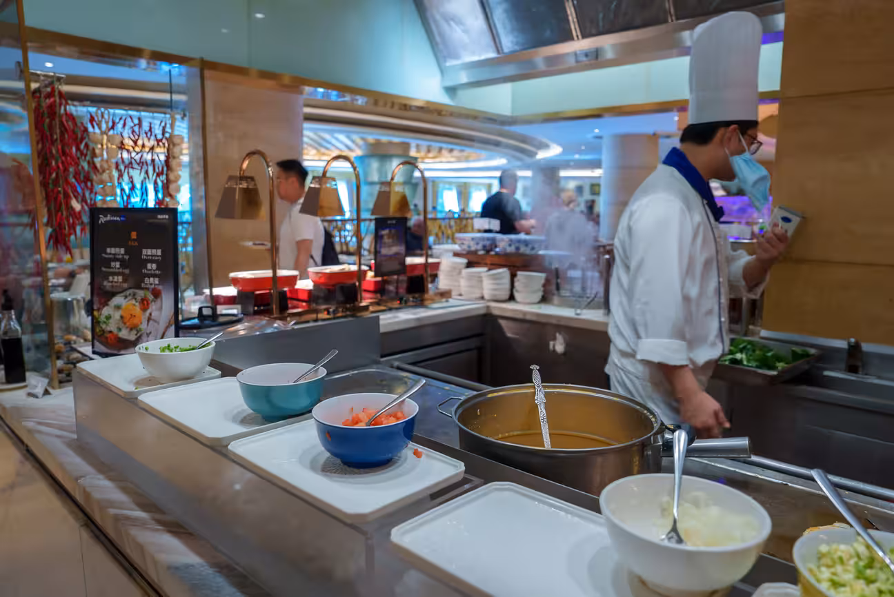 Luxury pavilion restaurant outdoor kitchen with chef at work, premium cooking setup, and refined dining atmosphere