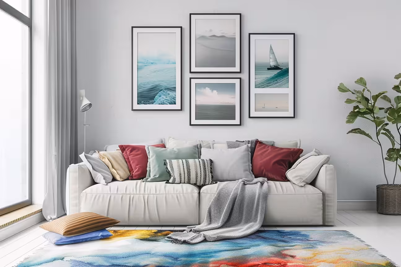 Bright living room with white sofa, colorful cushions, coastal wall art gallery, and soft natural lighting