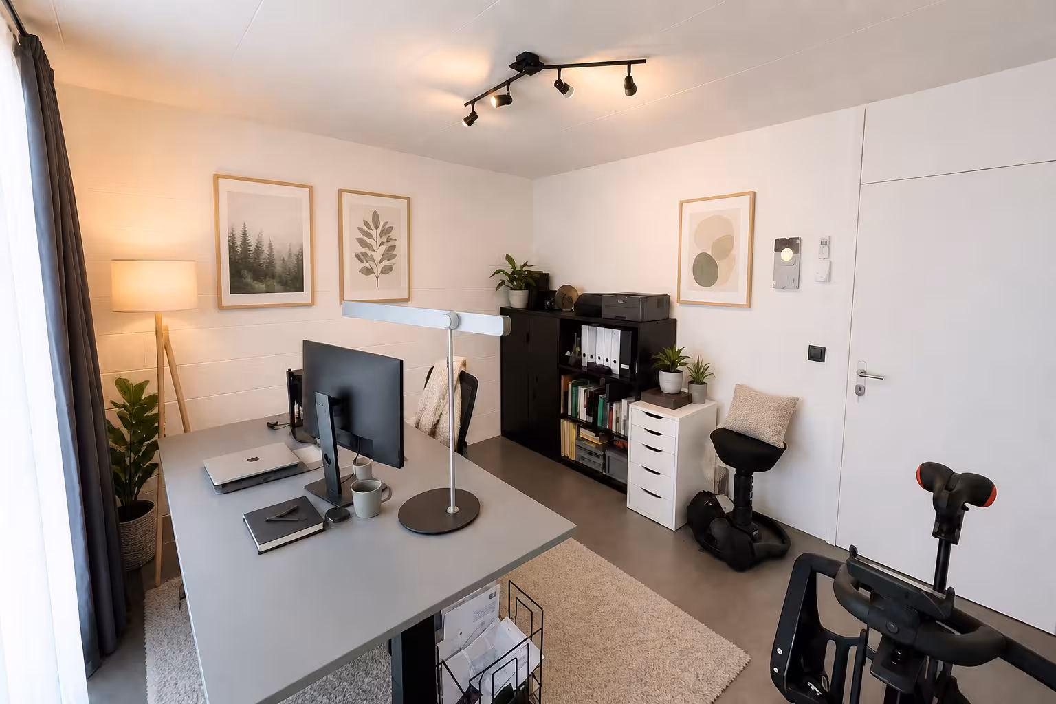 Modern home office with minimalist workspace, soft lighting, natural decor, and cozy neutral styling