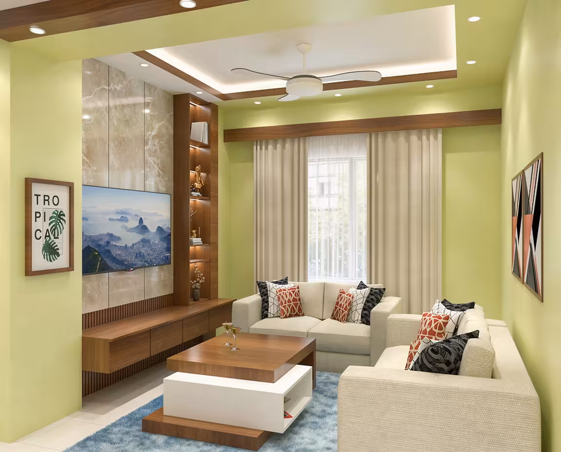 Contemporary living room with soft green walls, beige sectional sofas, wooden media console, geometric cushions, modern ceiling fan, and natural light.