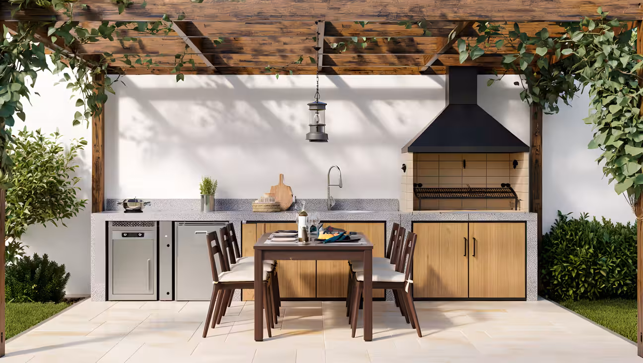 Pergola-covered single-wall outdoor kitchen with wood cabinetry, built-in grill, sink, dining table, and surrounding greenery