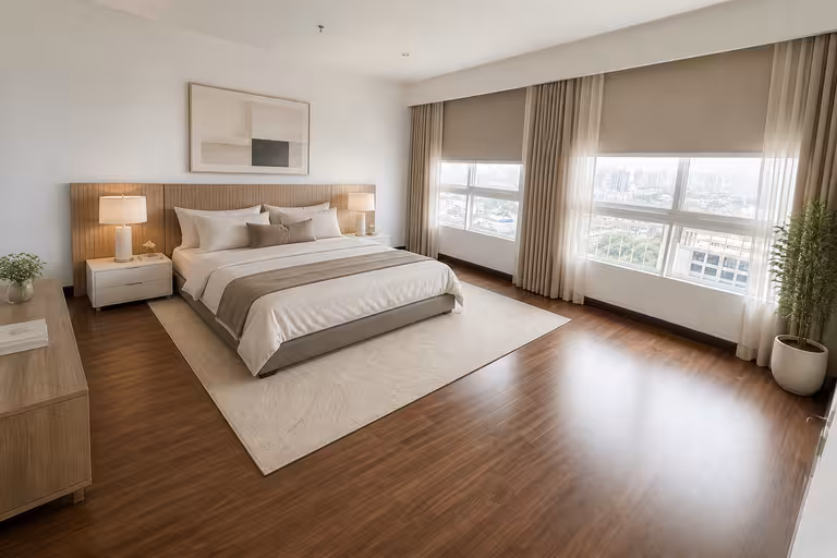 Contemporary apartment bedroom with large windows, neutral beige and white tones, wooden flooring, minimalist furniture, soft lighting, and a calm, airy atmosphere.
