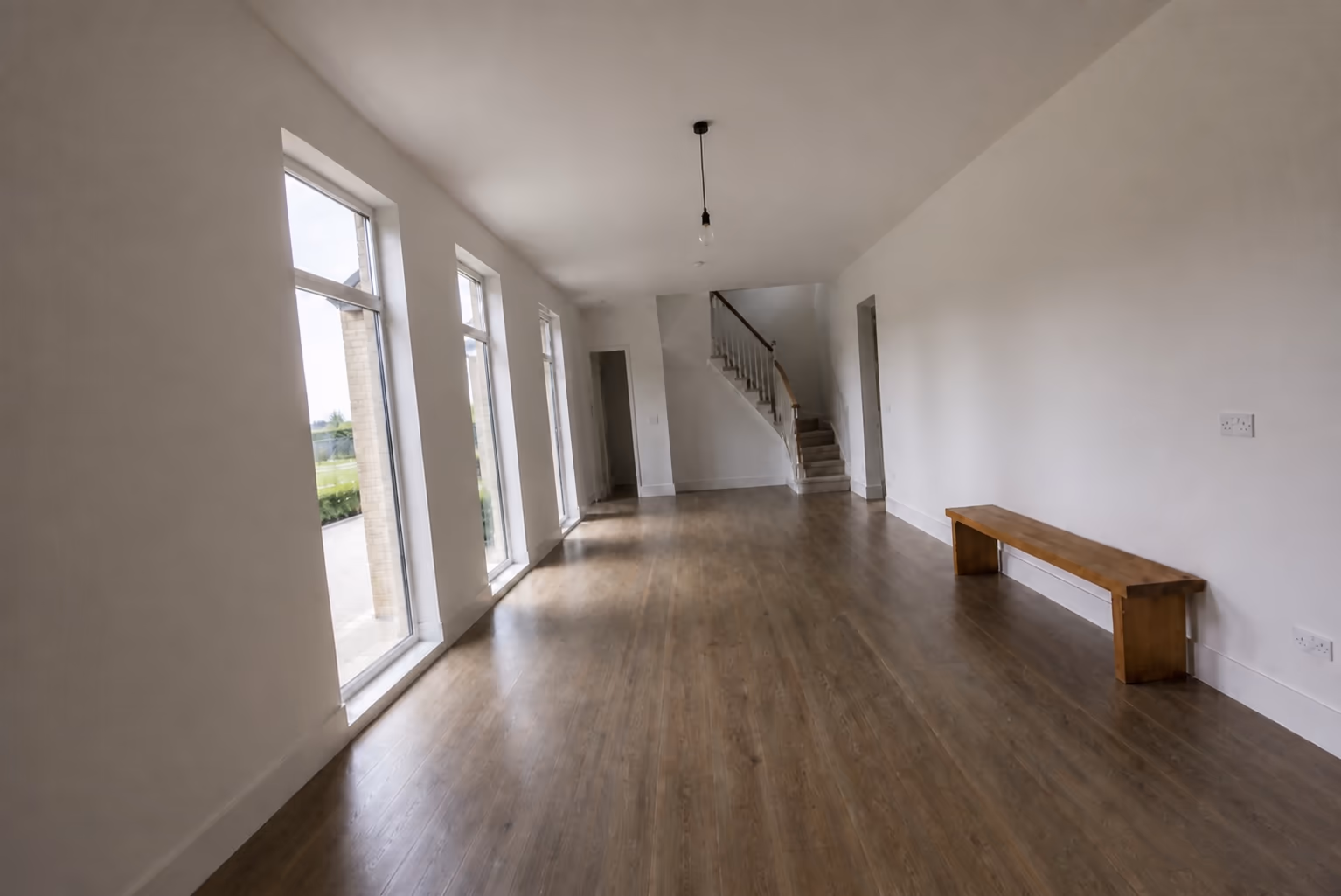 A bright, evenly lit photo of the same empty entrance hall showing the whole room