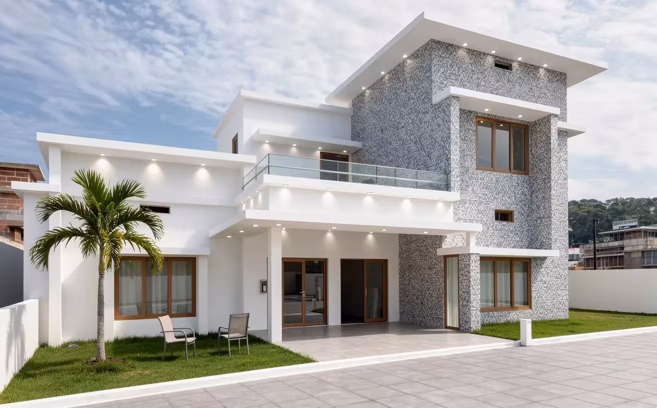 A contemporary two-story house exterior with white and textured gray walls, large windows, glass balcony, palm tree, minimal lawn, and modern outdoor seating.