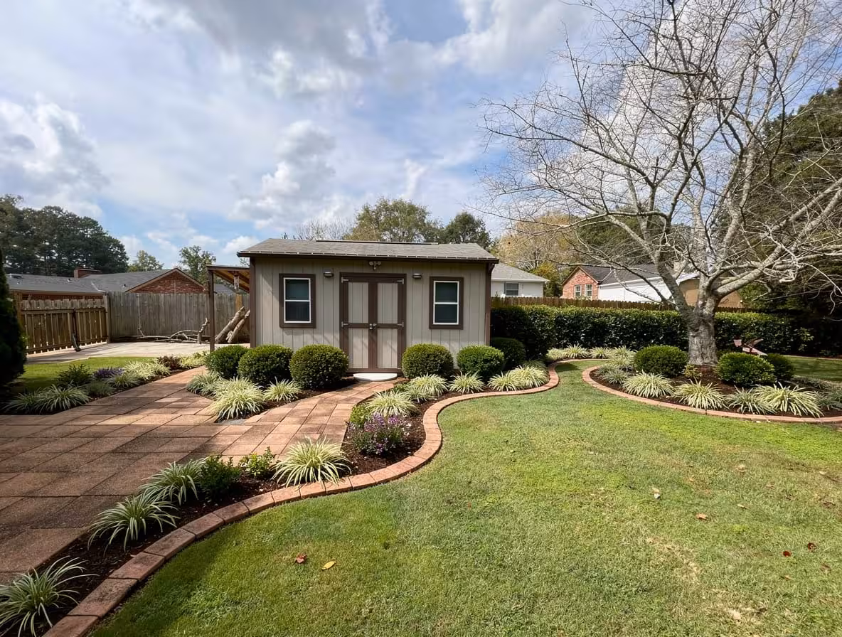 Southern backyard with curved garden borders, manicured shrubs, ornamental grasses, and landscaped shed pathway