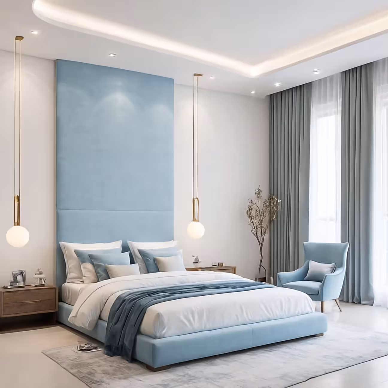 Minimalist bedroom with a tall pale blue upholstered headboard wall, two brass stem globe pendant lights, matching light blue armchair in the corner, layered white and grey bedding, and soft grey curtains