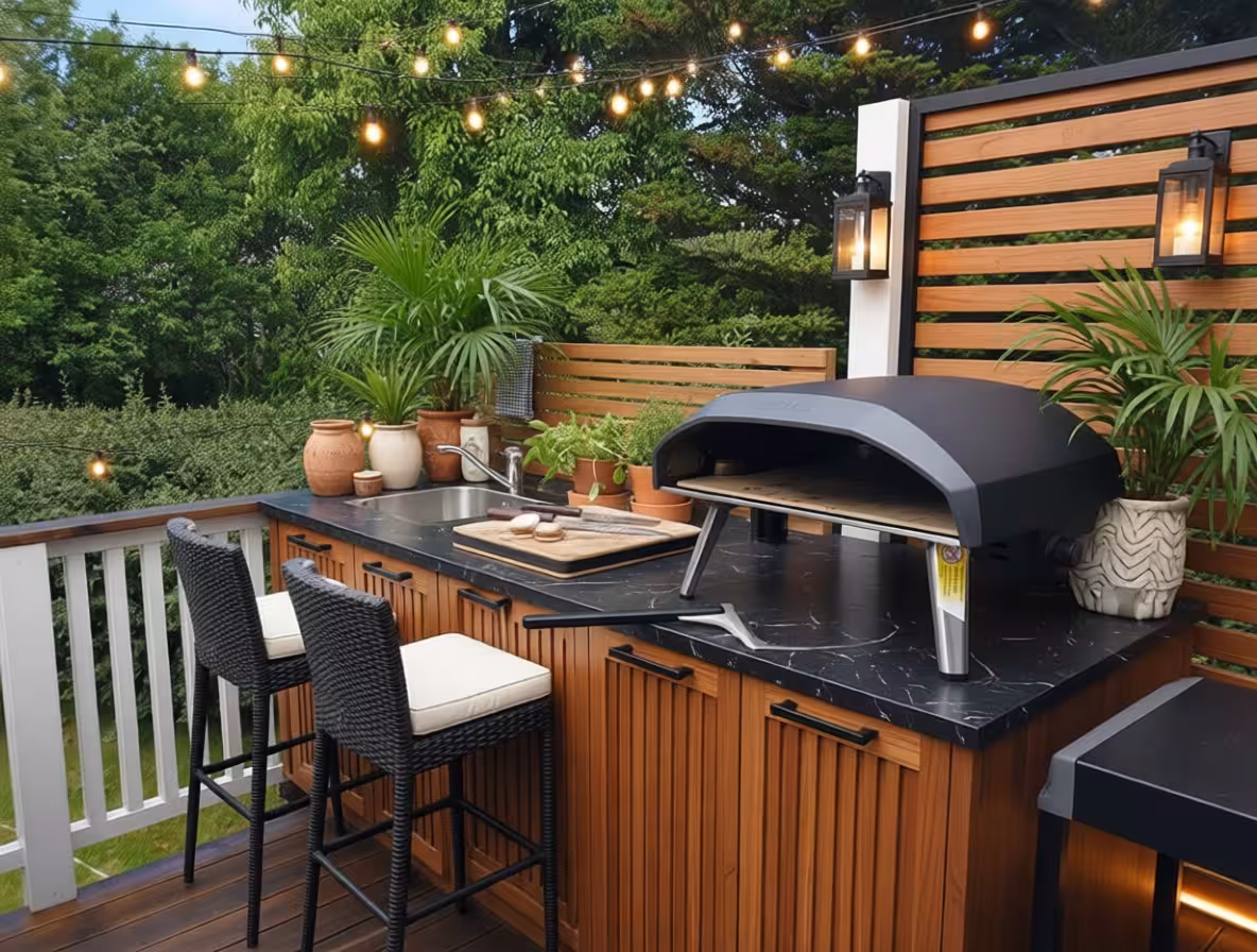 Modern Tropical outdoor kitchen with teak slat cabinetry, black countertops, and ambient string lighting