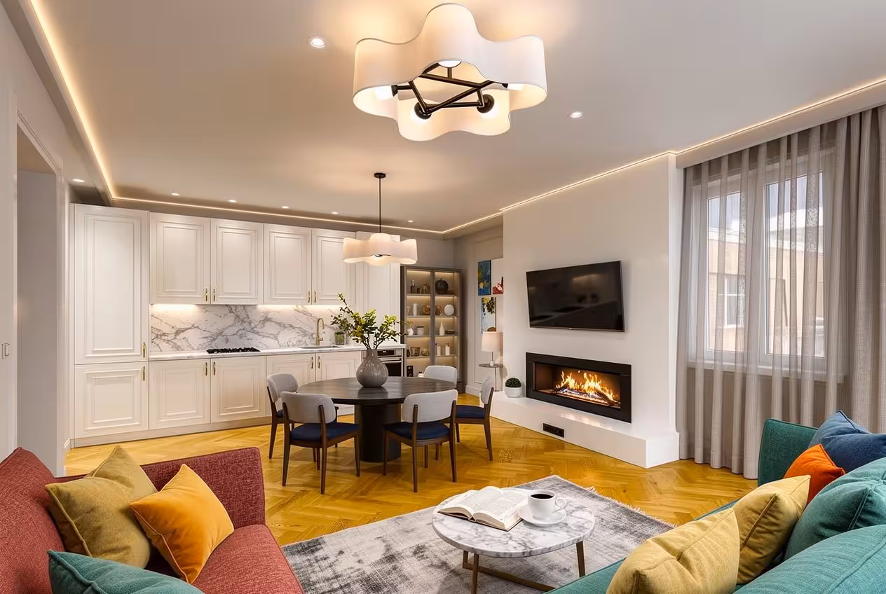 Modern open-concept living room with fireplace, marble kitchen, colorful sofas, and warm LED lighting