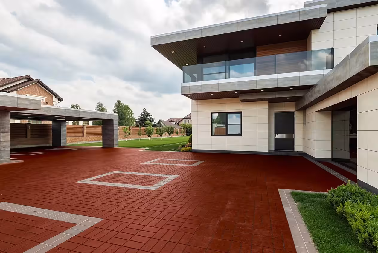 Modern house landscape with red brick courtyard, glass balconies, manicured lawn, and luxury exterior architecture