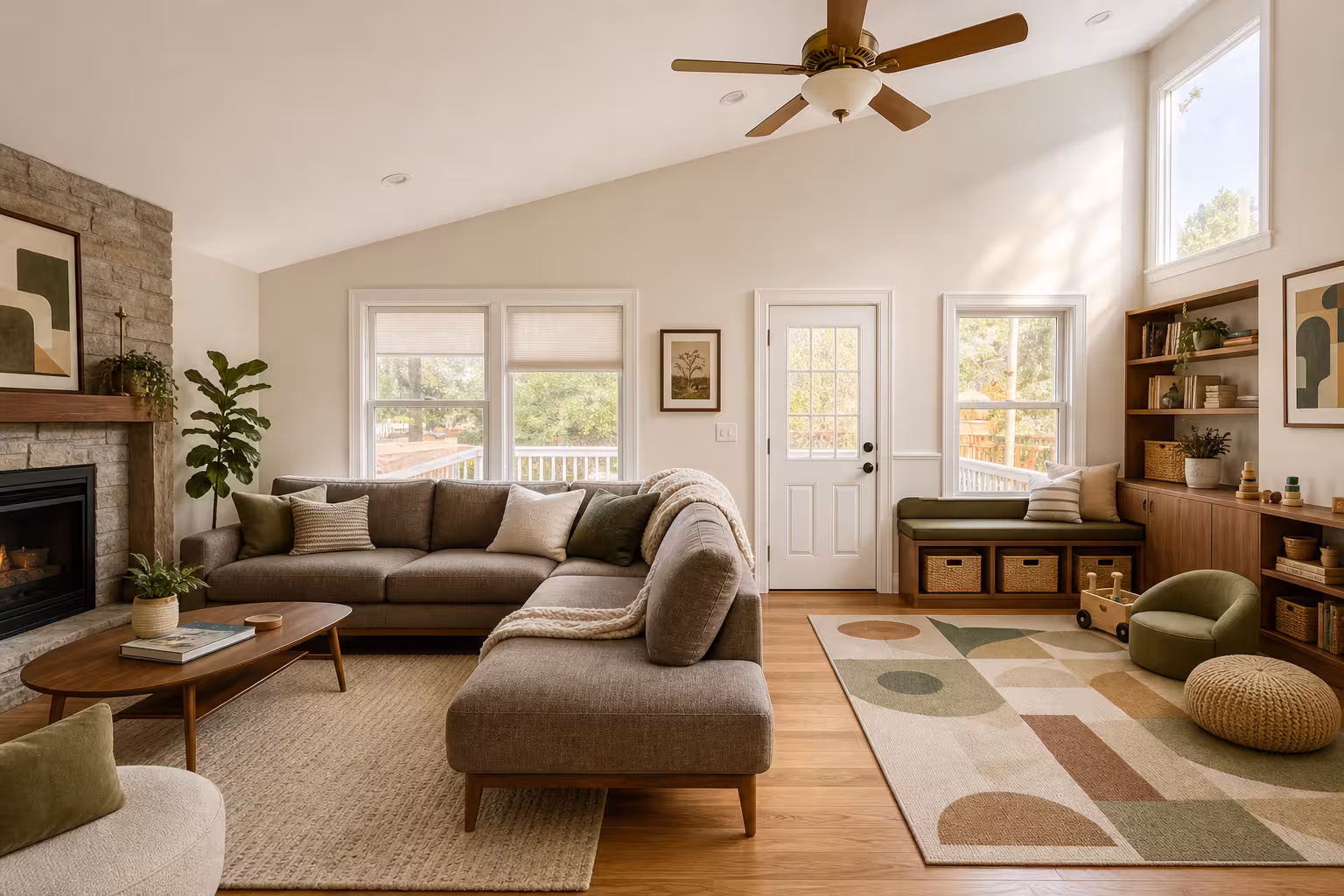 Modern Scandinavian family living room with built in toy storage, geometric rug, walnut finishes, and sectional seating.