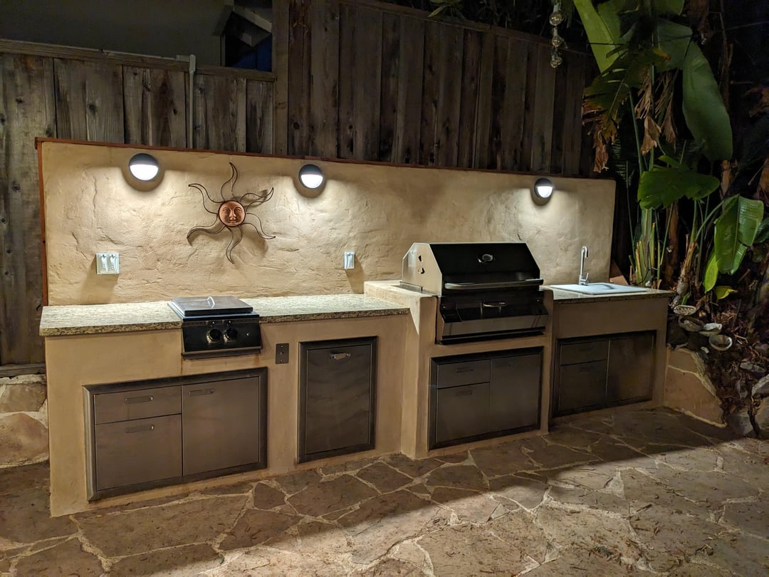 Basic outdoor kitchen with stucco walls and stainless steel grill