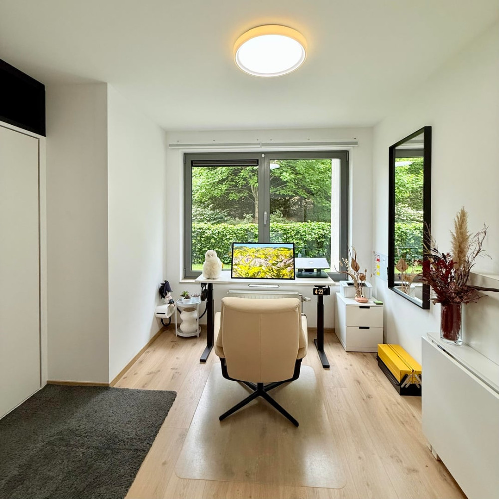Compact modern home office with simple desk setup and neutral walls